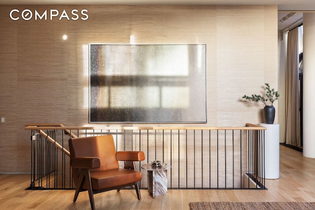 sitting room featuring radiator and hardwood / wood-style flooring