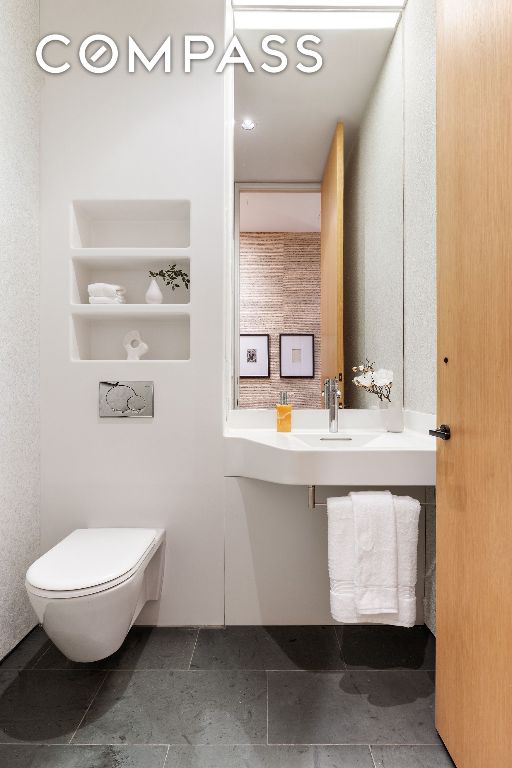 bathroom featuring toilet and sink