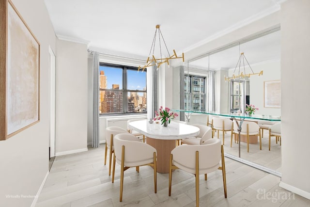 dining room with a notable chandelier, crown molding, and light wood-type flooring