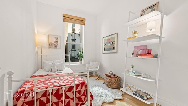 bedroom with hardwood / wood-style flooring