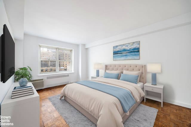 bedroom with radiator heating unit and dark parquet floors