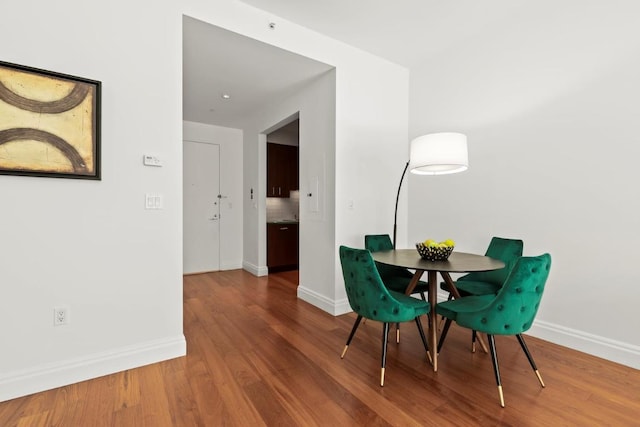 dining room with baseboards and wood finished floors