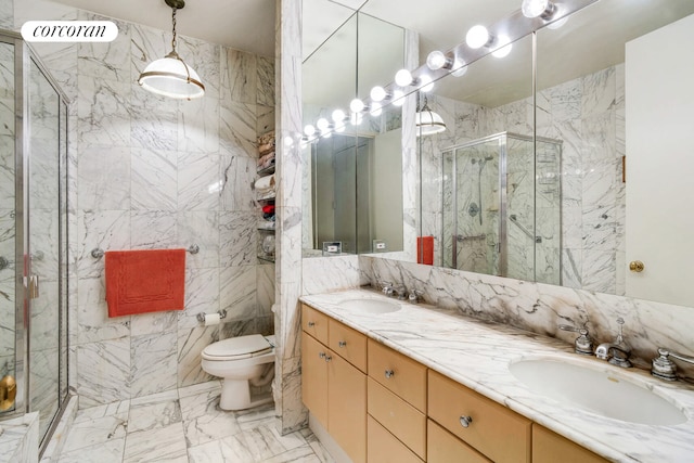 full bath featuring toilet, marble finish floor, a marble finish shower, and a sink