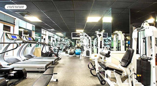 exercise room featuring a paneled ceiling and visible vents