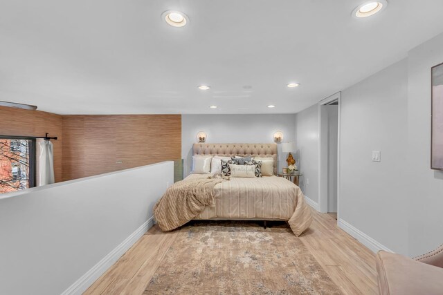 bedroom with ceiling fan and light hardwood / wood-style floors