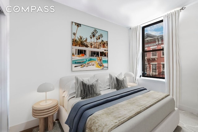 bedroom featuring baseboards and carpet floors