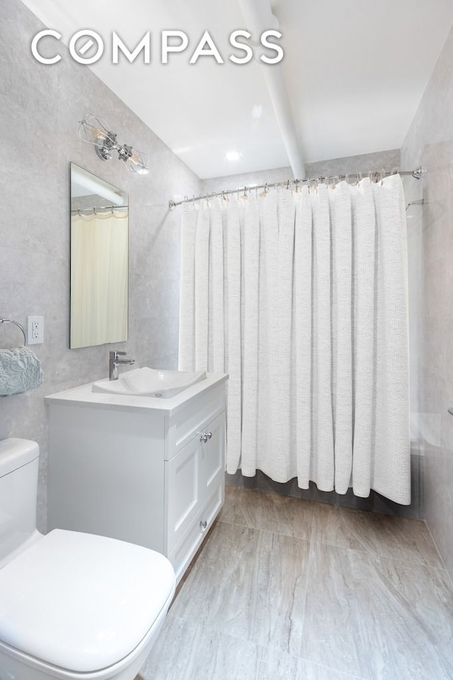 bathroom featuring radiator, toilet, tile walls, and vanity