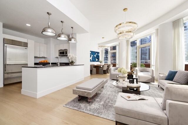 dining area with a notable chandelier and light wood-type flooring