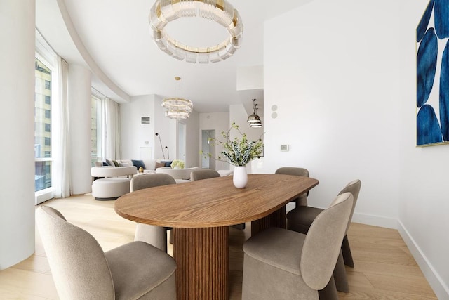 dining room featuring an inviting chandelier and light hardwood / wood-style flooring