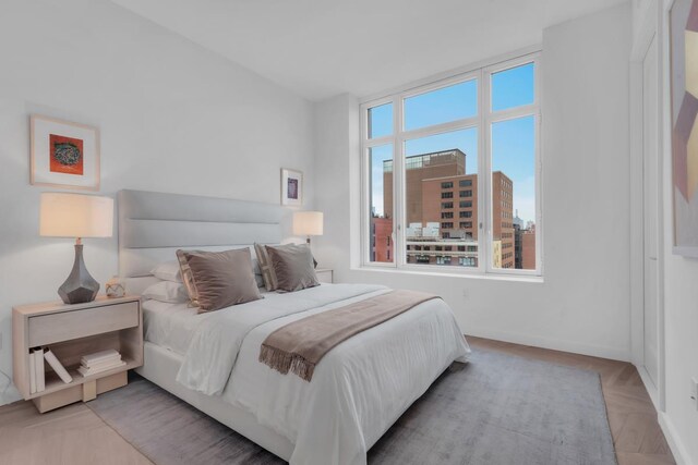 bedroom with light parquet flooring