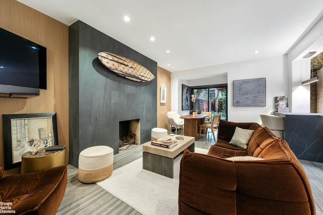 living room with a large fireplace and recessed lighting
