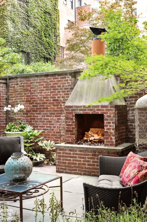 exterior space featuring an outdoor brick fireplace