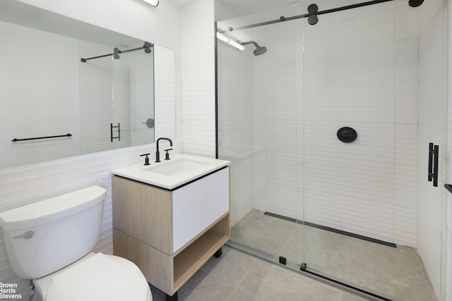 bathroom featuring tile patterned flooring, a shower stall, toilet, and vanity