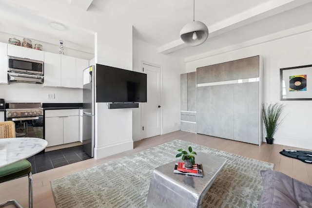 living room with hardwood / wood-style floors and beamed ceiling