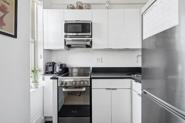 kitchen featuring appliances with stainless steel finishes and white cabinets