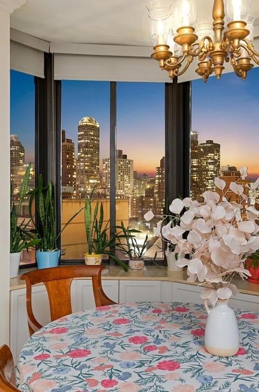 dining area with a notable chandelier and a city view