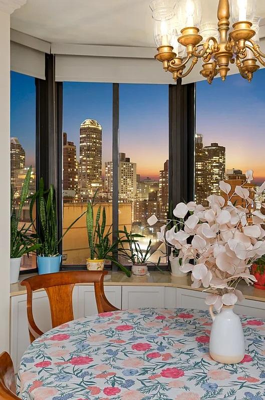 dining room featuring plenty of natural light, an inviting chandelier, and a view of city