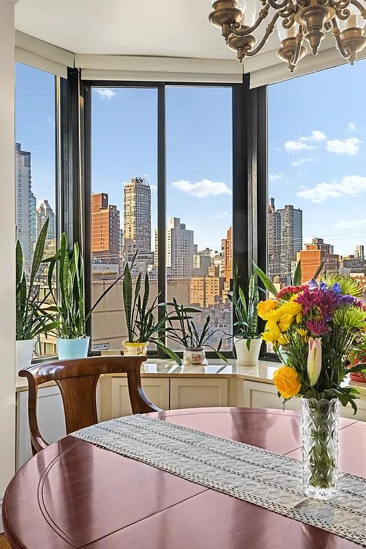dining room with a city view, a notable chandelier, and a wealth of natural light