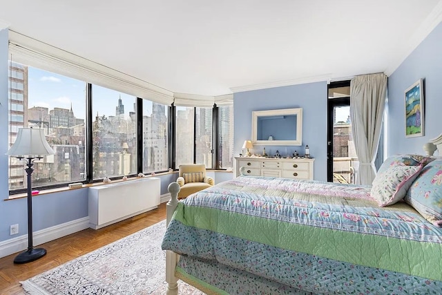 bedroom featuring baseboards, a view of city, and crown molding
