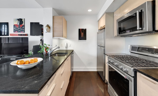 kitchen with dark wood-type flooring, sink, light brown cabinets, appliances with stainless steel finishes, and kitchen peninsula