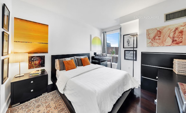 bedroom featuring visible vents and dark wood-type flooring