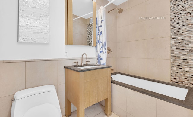 bathroom featuring tiled shower / bath, tile walls, toilet, and vanity