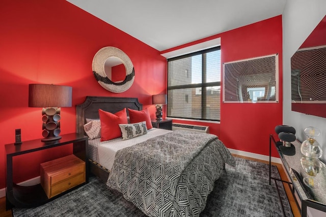 bedroom featuring vaulted ceiling and an AC wall unit