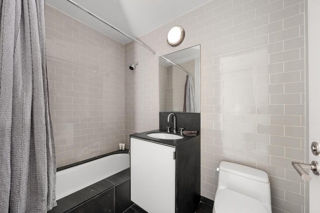 full bathroom with vanity, tile walls, shower / tub combo, and toilet