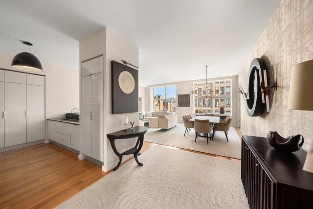 interior space with a notable chandelier and light wood-type flooring