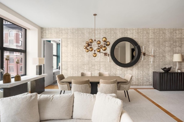 dining space featuring a chandelier and light wood-type flooring