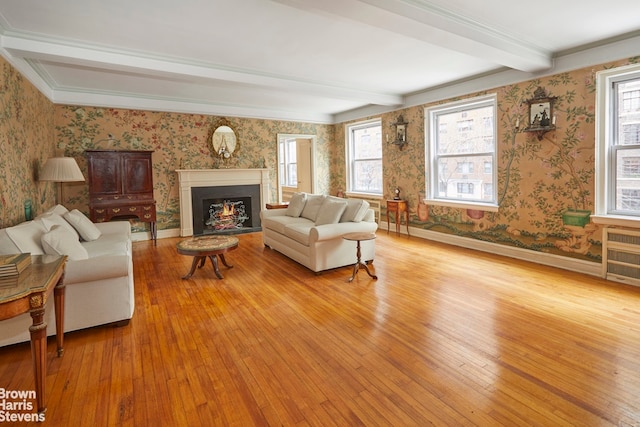 living room featuring light wood-type flooring and beam ceiling