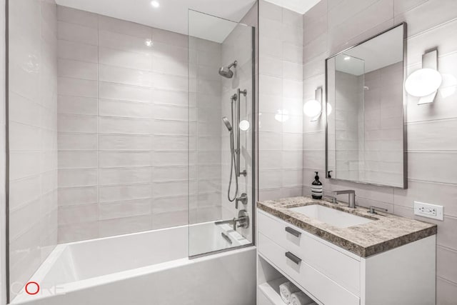 bathroom featuring vanity and tiled shower / bath combo