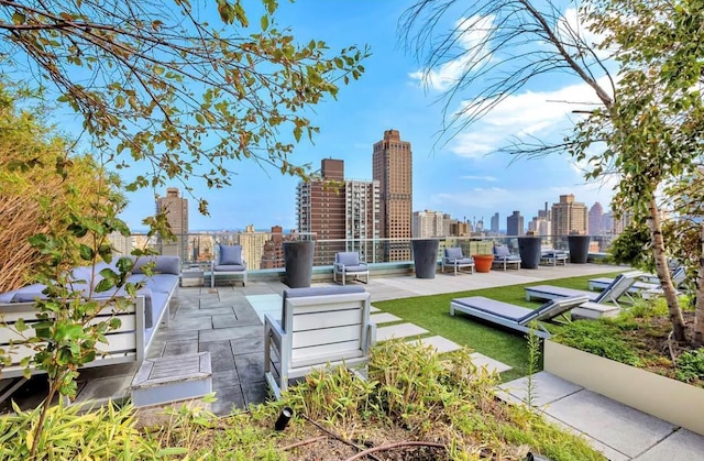 view of home's community featuring a patio area and a view of city