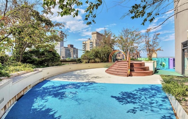 view of swimming pool with a view of city