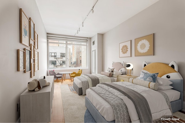 carpeted bedroom with rail lighting