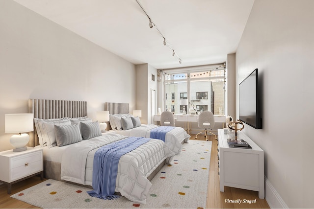 305 E 85th St Unit 3A, New York City, NY 10028 - bedroom featuring rail lighting and wood finished floors