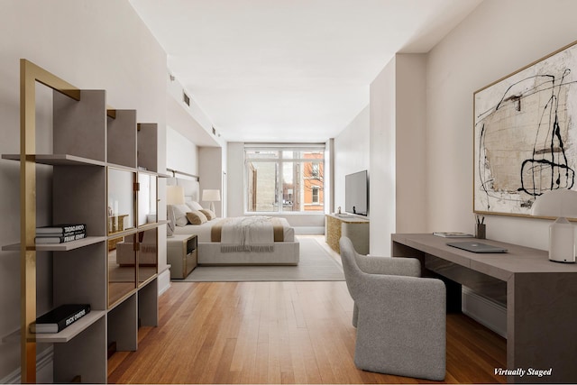 bedroom with light wood-type flooring and visible vents