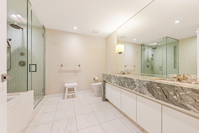 305 E 85th St Unit 3A, New York City, NY 10028 - bathroom with tile patterned floors, a stall shower, toilet, vanity, and recessed lighting