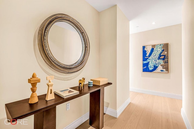 hallway with light hardwood / wood-style floors