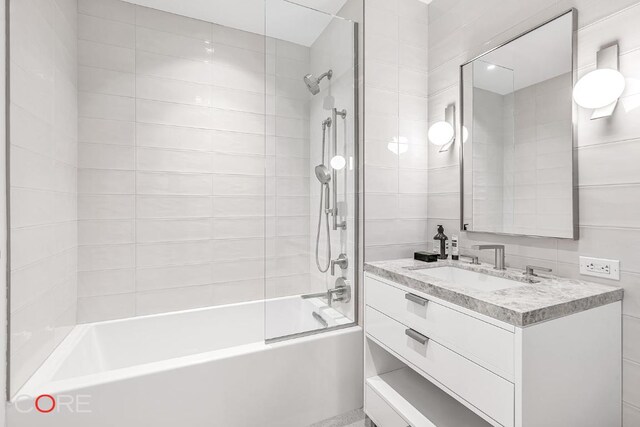 bathroom featuring vanity and tiled shower / bath combo