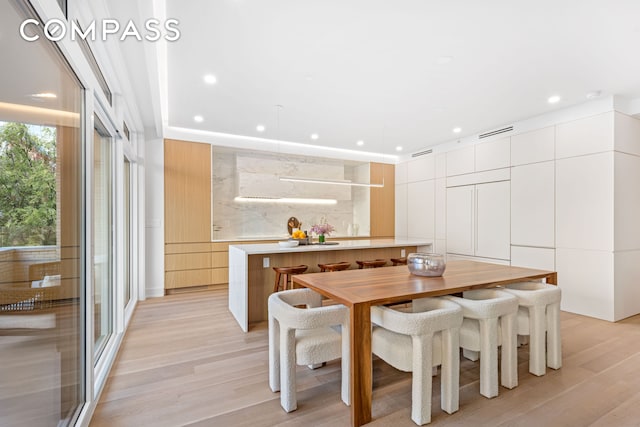 dining space featuring light hardwood / wood-style floors