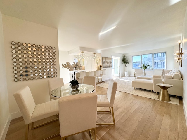 dining space with wood finished floors and baseboards