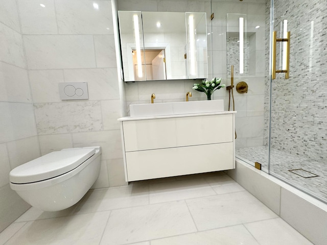 bathroom featuring toilet, a stall shower, vanity, and tile walls