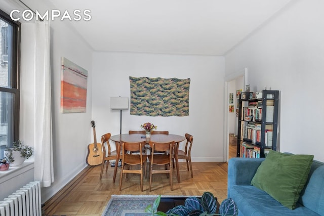 dining room with radiator and light parquet flooring