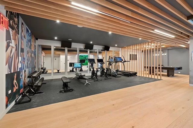 exercise room featuring wood finished floors