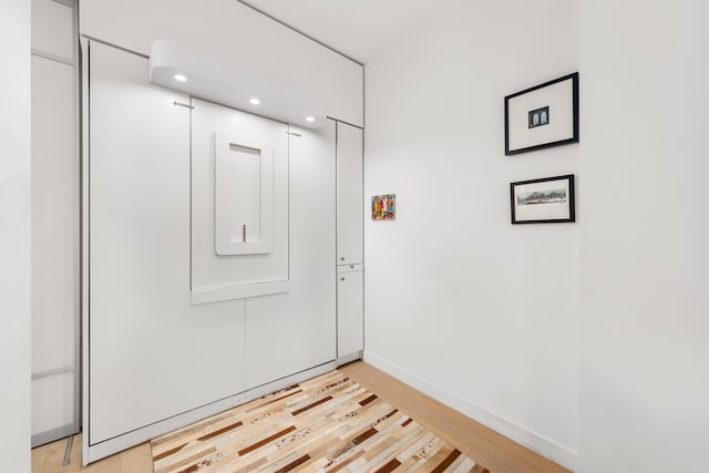 interior space with light wood-style floors, recessed lighting, and baseboards