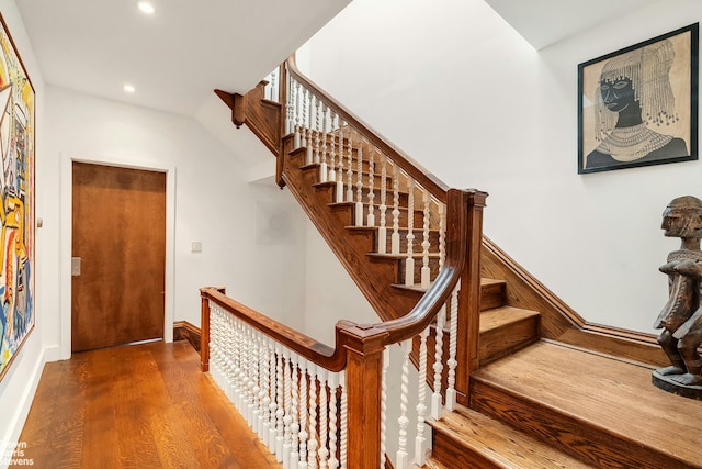 staircase with recessed lighting, baseboards, and wood finished floors