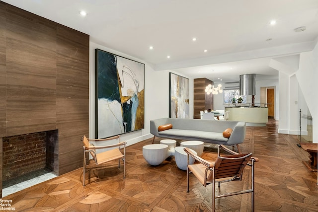 living room featuring a chandelier, recessed lighting, a fireplace, and baseboards