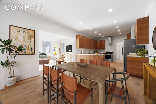 kitchen with recessed lighting, electric stove, light countertops, and light wood finished floors