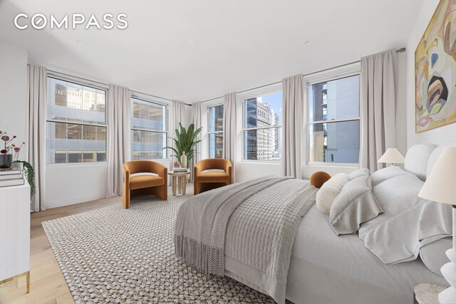 bedroom featuring multiple windows and light wood-type flooring